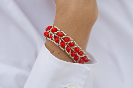 Stylish red bead bracelet on female hand - closeupの写真素材