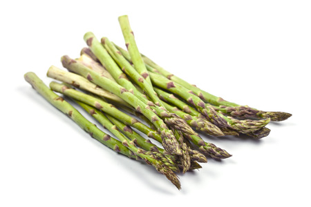 Bunch of fresh raw garden asparagus isolated on white background. Green spring vegetables. Edible sprouts of asparagus.の写真素材