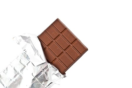 Top view of milk chocolate bar in foil isolated on white background. Closeup image.の写真素材