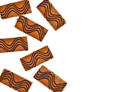 Cake bars filled with cream and decorated with dark chocolate isolated on white background. Top view with copy space.の写真素材