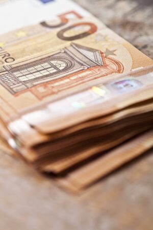 Pile of fifty euro banknotes. 50â‚¬ currency notes stacked. Money bank finance business concept....