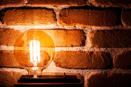 Illuminated grunge red brick wall background with copy space.の写真素材