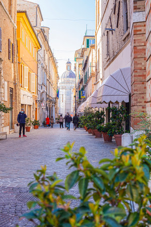 Macerata, Italy - February 21, 2021: People enjoying sunny day and outdoor and resting, wolking on...