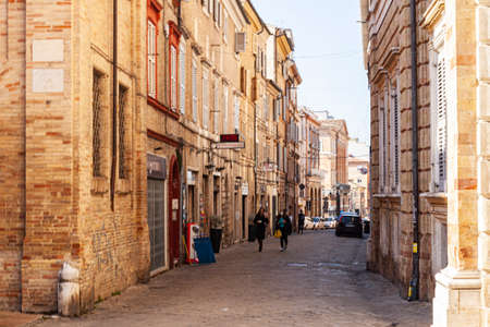Macerata, Italy - February 21, 2021: People enjoying sunny day and outdoor and resting, wolking on...
