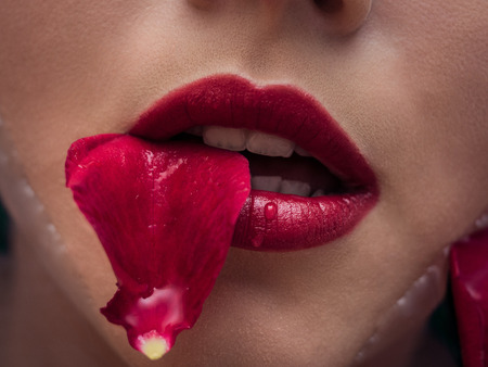 Closeup on attractive sensual woman relaxing in spa bath with flower rose petals backgroundの写真素材