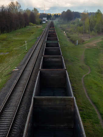 Fly view of railway tracks and empty freight train.