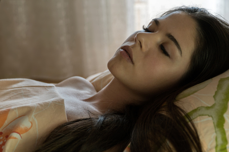 The girl is sleeping in the morning. Morning awakeningの写真素材