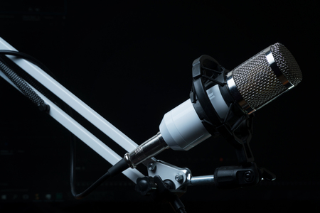 Professional condenser studio microphone on the black background.の写真素材