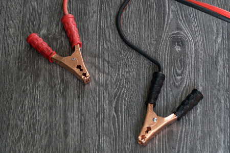 Terminals for recharging the car battery on the wooden floor.の写真素材