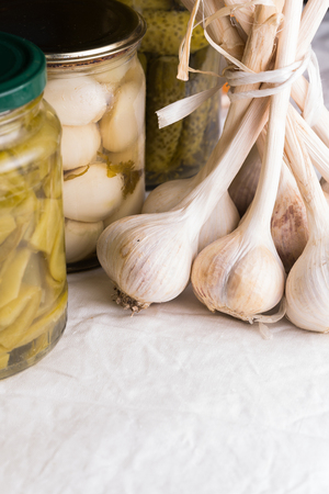 Jars with pickled vegetables on dark background.の写真素材