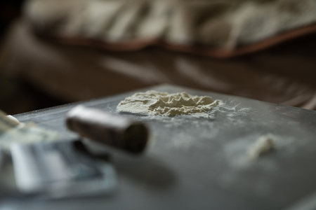 Drugs and money on a glass table.の写真素材