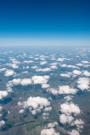 The blue sky among clouds and sunlightの写真素材