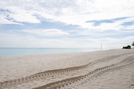 Wide sandy beach on a tropical island in Maldives. Wheel marksの写真素材