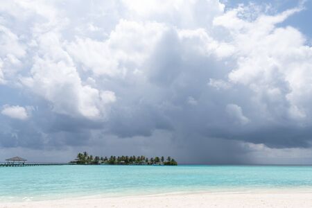 Wide sandy beach on a tropical island in Maldivesの写真素材