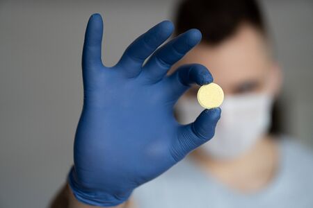 The medicine for coronavirus. The pill from the virus. Healthcare worker in the Coronavirus Covid19 pandemicの写真素材