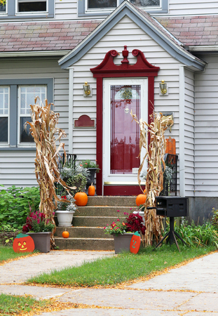 Main entrance of the stylish house decorated for autumn holidays. Vertical composition.の写真素材