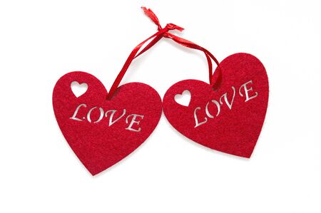 Close up, macro. Greeting Card on Valentine's Day. Two red felt hearts with an inscription love. Isolated on white background. Copy space.の写真素材