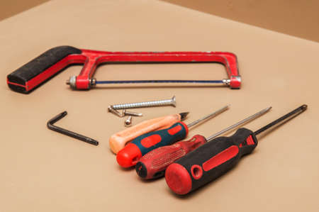 Close up, macro. Saw and screwdrivers set for cutting furniture fittings. Renovation work.