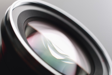 Camera lens close-up on gray backgroundの写真素材