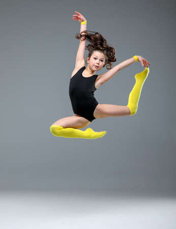rythmic gymnastic girl stretching in studio, ballet dancerの写真素材