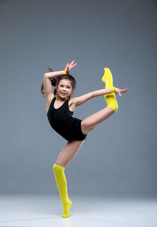 rythmic gymnastic girl stretching in studio, ballet dancerの写真素材