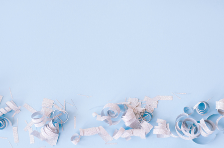 Silver confetti on a blue background. There is a place for text and logo.の写真素材
