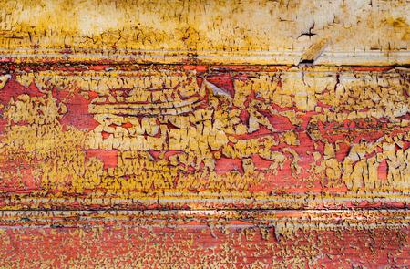 Wooden boards with traces of old yellow, red and  orange paint, textureの写真素材