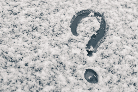 Finger-drawn Question Mark on a snow-covered windowの写真素材