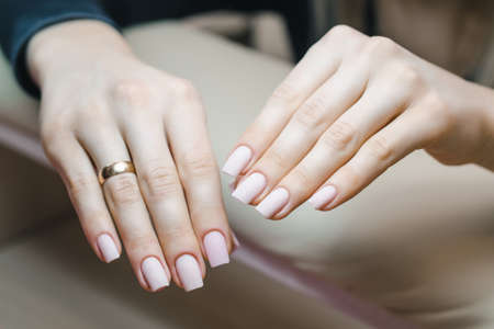 Beautiful well-groomed hands with nails after correction of gel coating of nails and before applying colored varnish close-upの写真素材