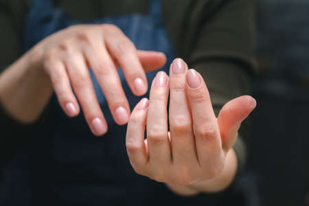 Well-groomed female hands with beautiful pink manicure, close-upの写真素材