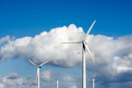 Wind turbines on a background of blue sky with white cloudsの写真素材
