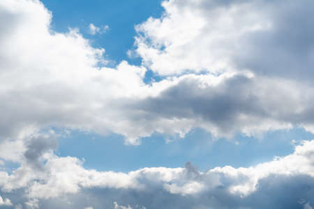 Spring blue sky with white clouds and skylights on a bright sunny day, soft focusの写真素材