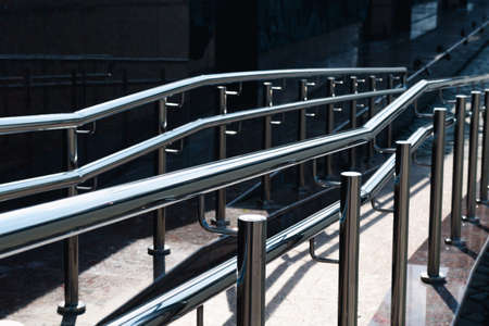 Irregular chrome ramp railing with bright highlightsの写真素材