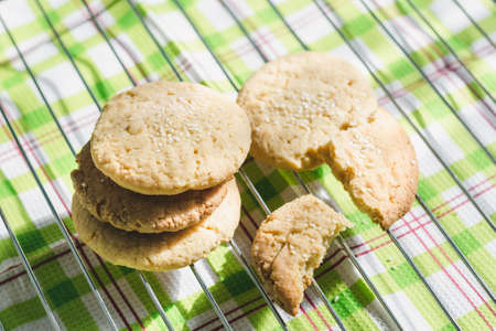 Round homemade shortbread cookies with sesame seeds cool down on a wire rackの写真素材