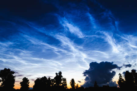 Mesospheric clouds in the darkening evening sky, a rare natural phenomenon, soft focusの写真素材