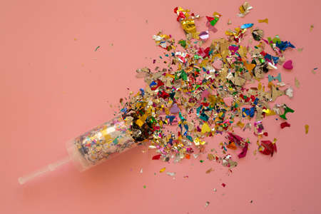 Multicolored sparkling candy on a pink background. Candy for your merry holiday. Heart candy for valentine's dayの写真素材