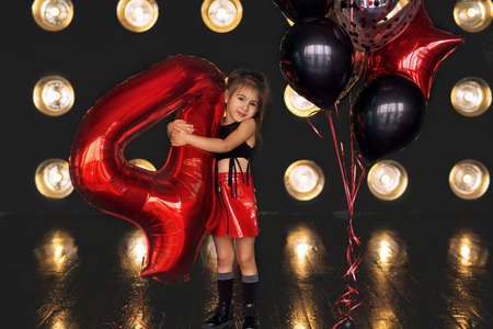 Girl dressed in rock style. Birthday baloons for party and celebrations. ballons abstract decoration. rock girl celebrating birthday.の写真素材