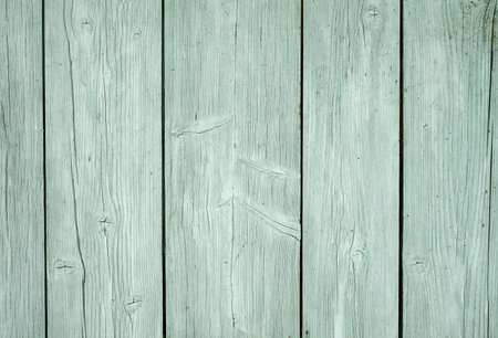 An old wooden floor with boards and a natural wood texture, painted with a light mint color paint. Wooden background made of planks and nails. Natural paint for wooden products and surfacesの写真素材