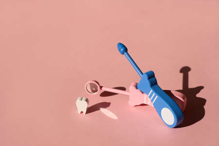 Model Tooth and Dental Probe and Dental mirror on pink background. Medical Dentist Tool for examination of teeth and oral cavity. Prevention and treatment of teeth.の写真素材