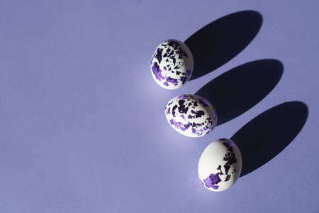 Easter eggs decorated with colored blue-purple foil on a Very Peri fashionable color background. Fashionable stylish painted eggs flat lay. Religious holiday of Holy Easterの写真素材