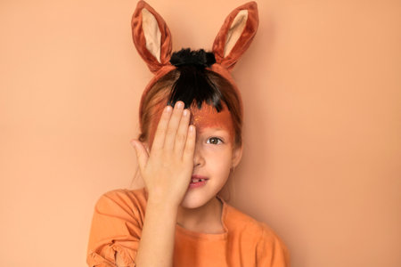 A surprised girl in a headband with ears on her head with horse makeup on her face. The symbol of the new year 2026の写真素材