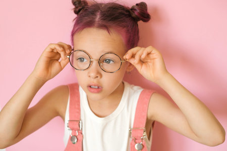 The girl puts on her eyeglasses and is surprised at her clear vision. World Sight Dayの写真素材