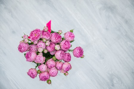 Garden flowers over grey wooden table background. Backdrop with copy spaceの写真素材