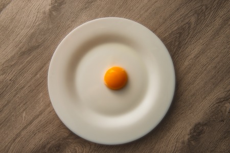 Egg yolk on white plateの写真素材