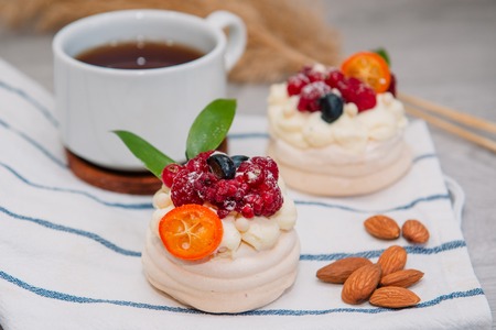 Pavlova meringue cake with cream and small fruitsの写真素材