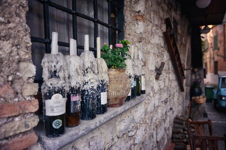 Quiet, italian street. The window of the house is decorated with candlesの写真素材