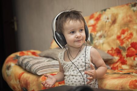 Charming boy listening to music in headphonesの写真素材