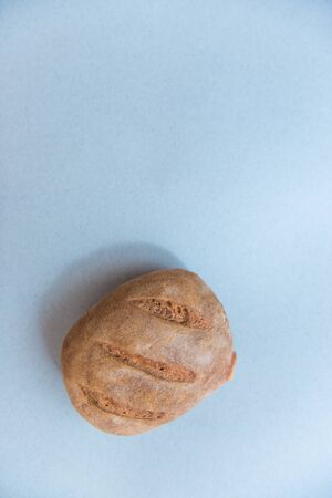 freshly baked bread isolated on blue background, top view
