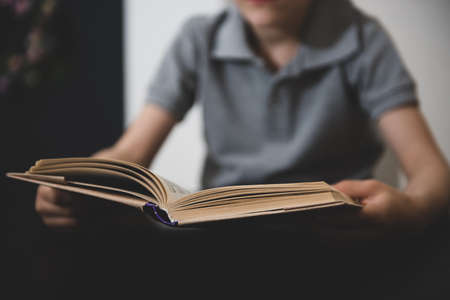 vague image of a boy reading a book