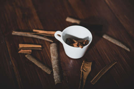 cinnamon on a white cup on a wooden backgroundの写真素材